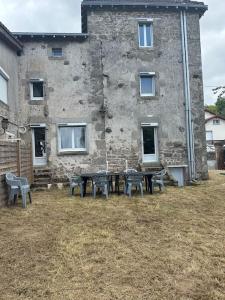 a table and chairs in front of a building at Maison familiale in Razès