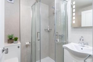 a bathroom with a shower and a sink at Woodside B & B in Keswick