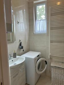 a small bathroom with a toilet and a sink at László Apartman in Debrecen +18 photos