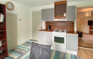 a kitchen with white cabinets and a stove at 2 Bedroom Stunning Apartment In Bodafors in Bodafors