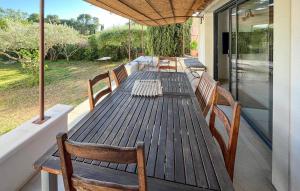 a wooden table and chairs on a deck at Awesome Home In Brignoles in Brignoles +20 photos