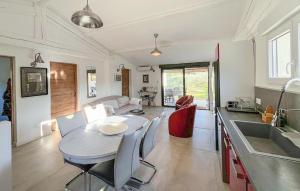 a kitchen and living room with a table and a table and chairs at Awesome Home In Brignoles in Brignoles