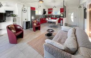a living room with a couch and chairs and a kitchen at Awesome Home In Brignoles in Brignoles
