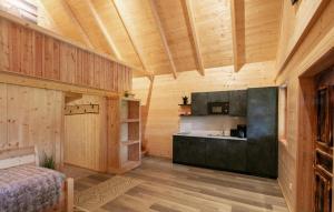 a kitchen with wooden walls and a wooden floor at Chalet Mit Gemeinsamen Pool in Stainz