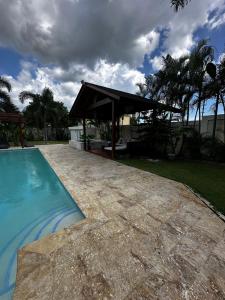 a swimming pool with a pavilion next to a house at Villa Valentina 