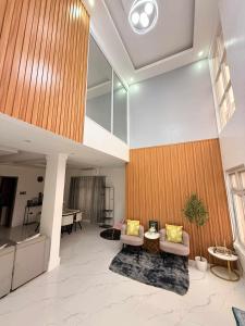 a living room with two chairs and a table at The GrayHouse Inn-Balcony,FullAc,open-space in Calumpit +18 photos
