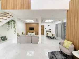 a living room with a kitchen and a dining room at The GrayHouse Inn-Balcony,FullAc,open-space in Calumpit