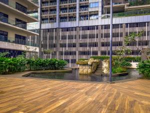 a building with a fountain in front of a building at 188 Suites by KidsCastle in Kuala Lumpur