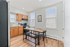 una cucina con un tavolo e delle sedie di Cozy Retreat 15Min to NYC MetLife Mall FREE Parking a Union City