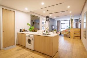 a kitchen with a sink and a washing machine at 188 Suites by KidsCastle in Kuala Lumpur
