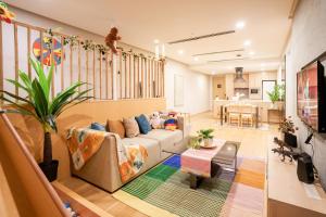 a living room with a couch and a table at 188 Suites by KidsCastle in Kuala Lumpur