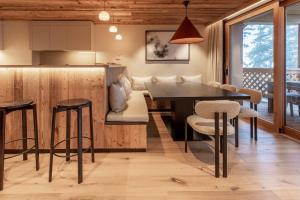 a kitchen and dining room with a table and chairs at Antarès ORION 202 - luxury apartment ski inski out in Méribel