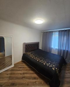 a bedroom with a bed and a window at Hercogs in Jelgava