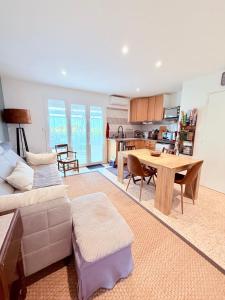 a living room with a couch and a table at Le Moorea - Apartment for 4 people in Hyères