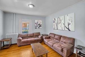 a living room with two couches and a table at The Wheelhouse All Star Baseball Rentals in Oneonta