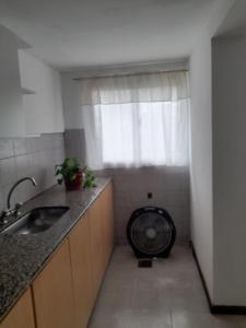 een kleine keuken met een wasmachine in een raam bij Complejo Vélez Sarsfield 185 in Bell Ville