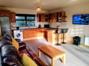 a kitchen with a couch and a table in a room at Ocean Winds in Wexford
