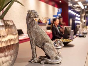 a statue of a dog sitting on a counter in a store at ibis Styles Muenchen Perlach in Munich