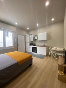 a bedroom with a bed and a kitchen with a table at Dreamhouse B&B in Pioltello
