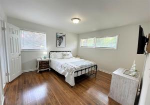 a bedroom with a bed and a table and windows at The Hilltop in Center Point