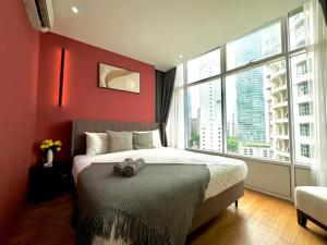 a red bedroom with a bed and a large window at Luxury Suites Twin Tower in Kuala Lumpur