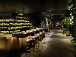 a bar with stools and a counter with wine bottles at Mercure Tokyu Stay Osaka Namba in Osaka