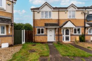 a brick house with a white door at Stylish 2-Bedroom House in Oldbury Sleeps 4 in Oldbury
