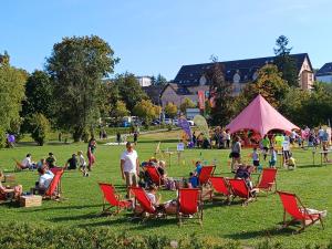 a group of people sitting in lawn chairs in a park at FeWo Oberhof - Tiefgarage und Parkplatz inklusive in Oberhof