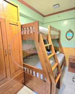 a couple of bunk beds in a room at Goshenland Towers 2BR Baguio Condo by Dei Gratia in Baguio