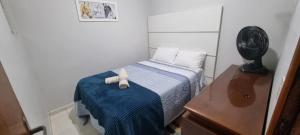 a small bedroom with a bed with a stuffed animal on it at STRELART RESIDENCE in Brasilia