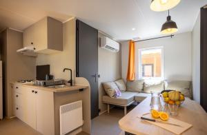 a small apartment with a kitchen and a living room at Camping maeva Escapades Le Hameau des Pins in La Crau +37 photos