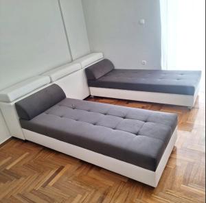 two beds sitting in a room with ainylinylinylinylinyl at MARIAS APARTMENT SMART KEY BOX by WESTBOOKING GR in Agrinio