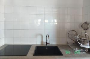 a kitchen counter with a sink and aaucet at "Lagon Bleu" Duplex lumineux à St Gilles les Bains in Saint-Paul +16 photos