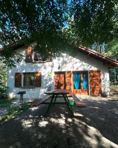 a picnic table in front of a house at Gîtes de Charme en Isère in Sonnay