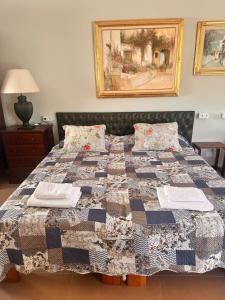 a bedroom with a bed with a quilt on it at Villa IRI Habitación N 4 - Suit con balcón in Pineda de Mar