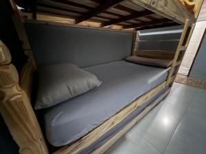 a wooden bunk bed in a room with a mattress at House Amorim 13 min Parque peão in Barretos