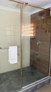 a shower with a glass door in a bathroom at Dview Hotel in Lagos +18 photos