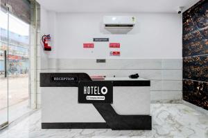 a hotel lobby with a reception desk in a building at Hotel O Rohini Sector 21 Shelter Inn in New Delhi