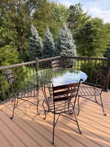 a glass table and chairs on a deck at Cozy Gurnee Home Near Six Flags and Base in Gurnee