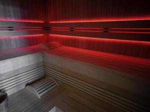 a bench in a room with red lights at Mercure Hotel Delémont in Delémont