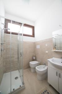 a bathroom with a shower and a toilet and a sink at Raggio Di Sale in Trapani