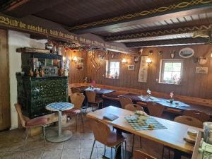 a restaurant with tables and chairs in a room at FEWO Torfhaus Holzhau in Rechenberg-Bienenmühle