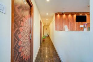 a hallway with a wall with a tv on it at Collection O Neredmet Road in Hyderabad