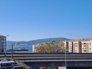a view of a city with cars parked on a bridge at Habitación 1º IZQ H2 vistas a la ría in Vigo