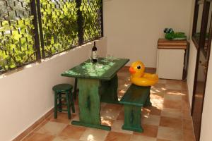 a table with a bottle of wine and a rubber duck at Robinson Hotel in Zatoka