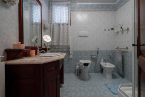 a bathroom with a sink and a toilet and a shower at San Mauro Prestige House - Burano Island in Venice +69 photos