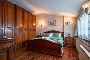 a bedroom with a bed and wooden cabinets at San Mauro Prestige House - Burano Island in Venice