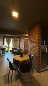 a room with a table and chairs and a brick wall at TempoJUY in San Salvador de Jujuy