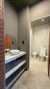 a bathroom with two sinks and a toilet at TempoJUY in San Salvador de Jujuy