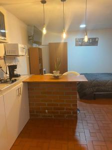 a kitchen with a brick island in a room at CANEY Traveller House in Cali